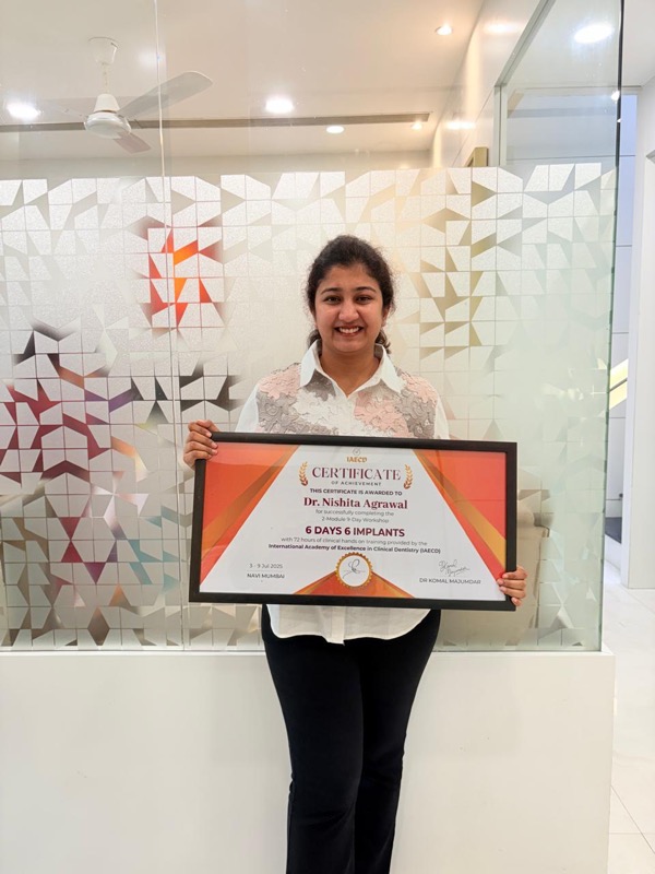 Dr. Nishita with implantology certificate